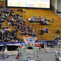 Robots shoot balls during the beginning of a match